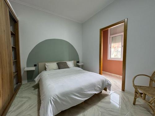 a bedroom with a large white bed and a window at Charming apartment heart of Medina Tetouan 2BR in Tetouan