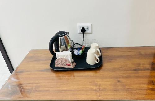 a kitchen utensil organizer sitting on a wooden table at Murthal Green Plaza Hotel in Sonīpat