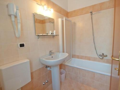 ein Badezimmer mit einem Waschbecken, einer Dusche und einer Badewanne in der Unterkunft Residence Hotel Moderno in Gaby