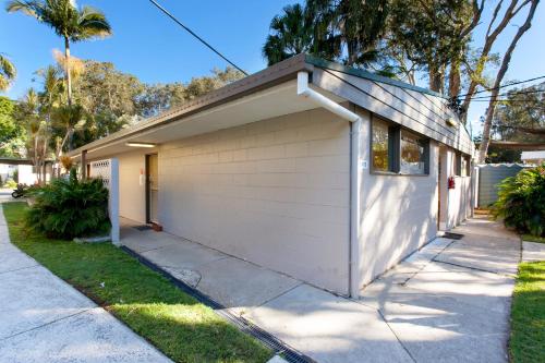a house with a garage on a street at Sapphire Beach Holiday Park in Coffs Harbour