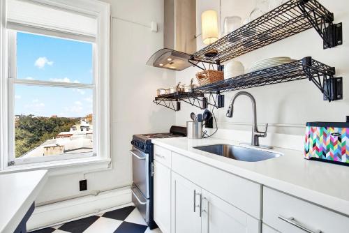 a kitchen with a sink and a window at Downtown at the Derenne in Savannah