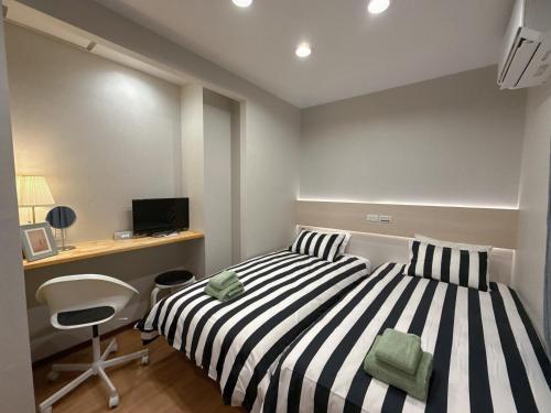 a bedroom with a black and white striped bed and a desk at YY-Minamicho 1 room-IT0339 in Tokyo