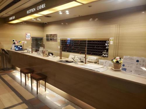 a counter in a wine shop with two stools at Hotel Castle Plaza in Kobe