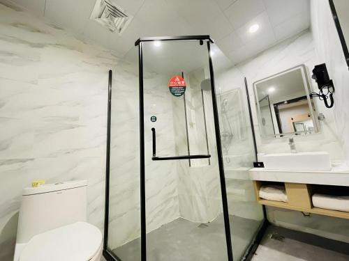 a bathroom with a shower and a toilet and a sink at GreenTree Inn Anhui Suzhou Baima Mall Express Hotel in Suzhou