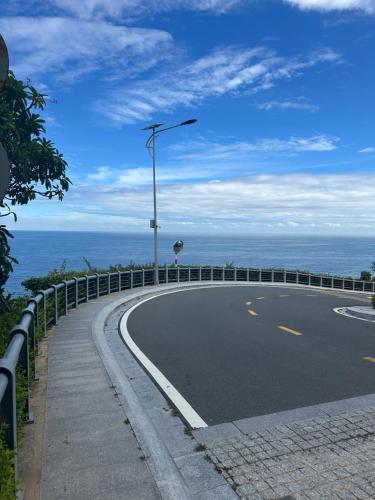 a curvy road with a street light on the side of the ocean at Apec mandala Apartment - APEC Mandala Ocean View Mũi né-R0234 in Mui Ne