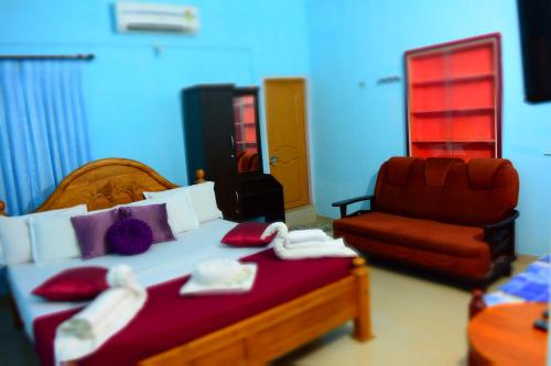 a hotel room with a bed and a chair at Stream Garden Mountain Resort in Kalpetta
