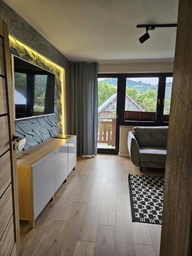 a hotel room with a bathroom with a large window at GOLD apartamenty & spa in Szczawnica