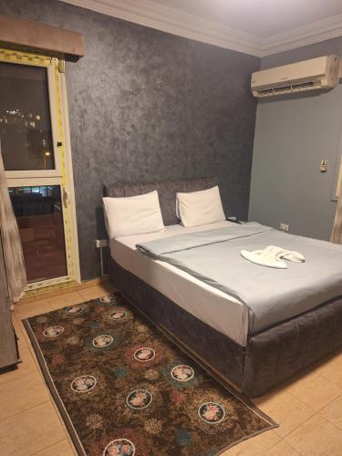a bedroom with a large bed with a rug at Elgabry pyramids inn in Cairo