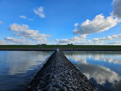 a road leading into a body of water at Ferienwohnung Friesenhaus in Butjadingen