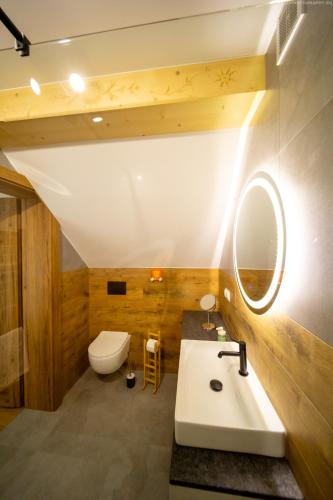 a bathroom with a sink and a toilet and a mirror at !! Dom nad Chmurami w Pieninach - BALIA & SAUNA - Piękny Widok na SZCZAWNICĘ !! in Szczawnica