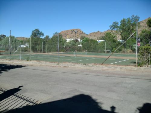 an empty tennis court with two tennis courts at The Barracks in Colesberg