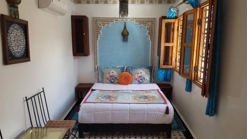 a bedroom with a bed in the corner of a room at Dar Nour Fes - Luxury lodging in Fès