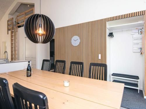 a conference room with a wooden table and chairs at 8 person holiday home in Ringkøbing in Ringkøbing