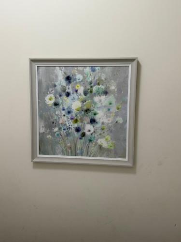 a painting of flowers hanging on a wall at Oban Victoria Hotel in London