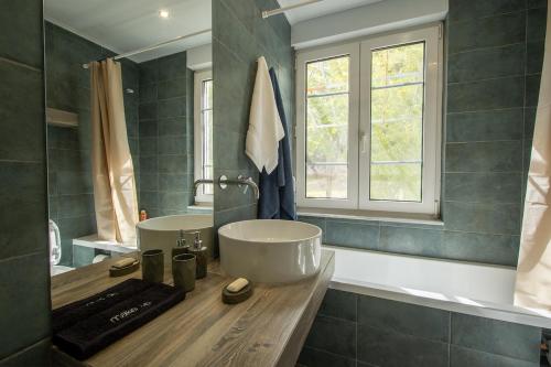 a bathroom with a sink and a window at Olive Grove Retreat in Mytilini