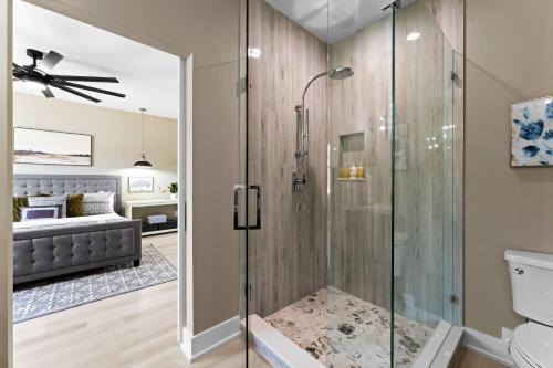 a bathroom with a shower with a glass door at Salience Path w/Heated Pool & Game Room in Mooresville