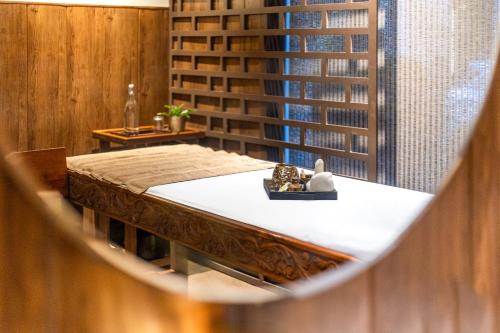 a table in a room with a book shelf at Sterling Palm Bliss - Rishikesh in Rishīkesh