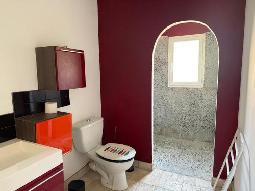 a bathroom with a white toilet and a window at Authentic fisherman's house Maison de pêcheur authentique in Port-la-Nouvelle
