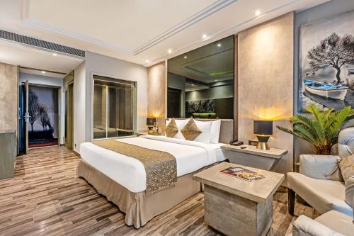 a hotel room with a large bed and a couch at Sterling Palm Bliss - Rishikesh in Rishīkesh