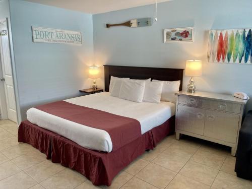 a bedroom with a large bed and a night stand at One-Bedroom Apartment in Port Aransas