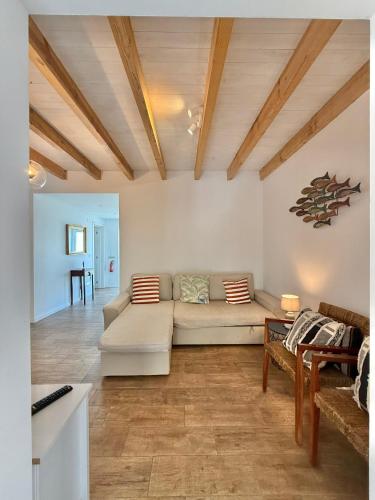 a living room with a couch and a table at CAPARICA BEACH VILLA in Trafaria