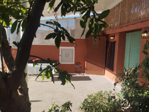 a courtyard of a house with a chair at Alojamiento rural casa cueva abuelo Miguel in Pegalajar