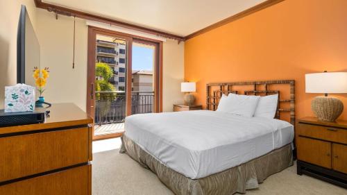 a bedroom with a bed and a tv and a window at Beachfront Condo at Beach Villas at Ko Olina Hale Hoaloha by AvantStay in Honokai Hale