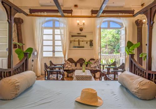 a hat sitting on a table in a living room at Private pool heritage villa in Cavelossim area in Velim