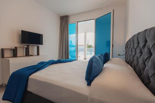 Ένα ή περισσότερα κρεβάτια σε δωμάτιο στο Laguna Blu