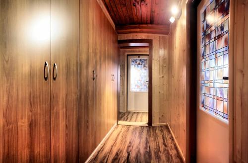 a hallway with wood paneling and a glass door at Pension U Stehlíků in Růžová