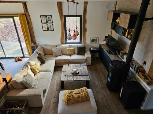 a living room with a couch and a table at Villa Rustique Le Carriou in Léon