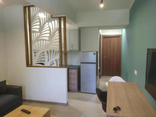 a small kitchen with a refrigerator and a table at Stylianos House 6 in Leonidion