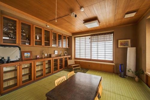 a dining room with a table and a large window at Traditional Japanese House, MtFuji view ,Free bag ,4 bedrooms ,Rent bike in Fujiyoshida