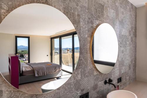 a bedroom with a mirror and a bed and a sink at VILLAS COSETTTE Villa VICENC in Platja  d'Aro