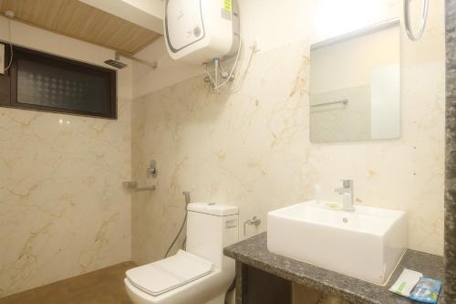 a bathroom with a white toilet and a sink at TVD Hotel Polaris Gangtok Near MG Marg in Gangtok