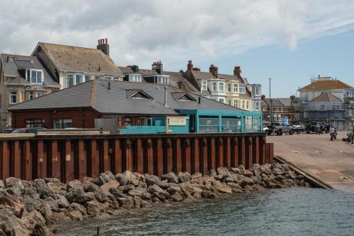 a group of buildings next to a body of water at The Beach House in Exmouth