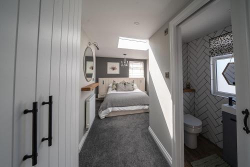 a small bedroom with a bed and a window at Seaside 5-Bed Coastal Getaway in Exmouth