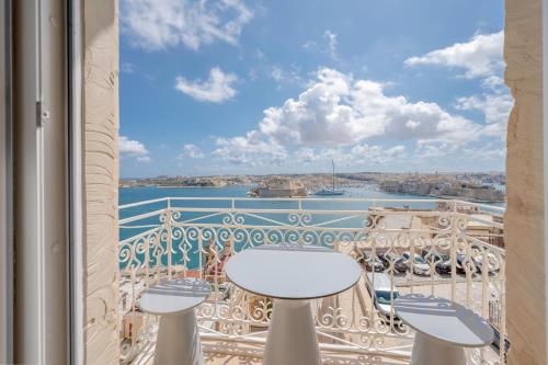 a balcony with a view of the water at V60 Valletta in Valletta