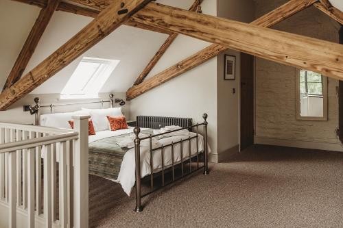 a bedroom with a bed in a room with wooden ceilings at Ty Mawr, The Old School Holiday Homes in Llanwrtyd Wells