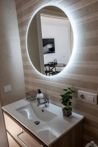 a bathroom with a sink and a mirror at Vivienda rural La Puentezuela in Grazalema