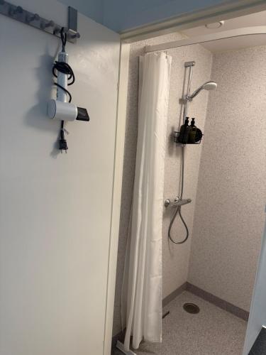 a shower in a bathroom with a shower curtain at Bright and inviting apartment in Frederiksberg in Copenhagen