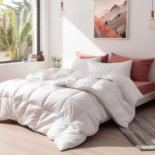 a bed with a white comforter in a bedroom at Royal properties thika jomoko in Thika