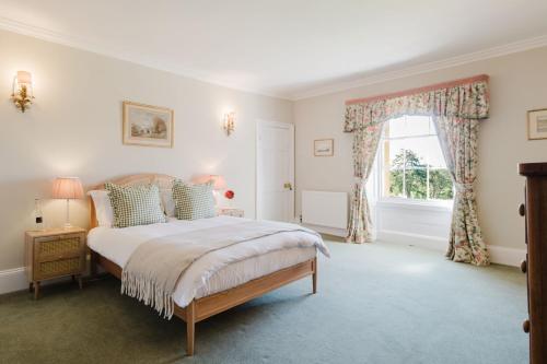 a bedroom with a bed and a window at Hopton Court Apartment in Hopton Wafers