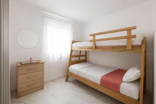 Cama o camas de una habitación en APARTAMENTO FAMIliar MELGAR