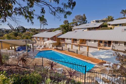 an image of a house with a swimming pool at Tathra Beach House Holiday Apartments in Tathra