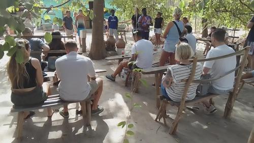 a group of people sitting on park benches at Jallo Kurundingoto Eco Tourist Camp in Nyofelleh