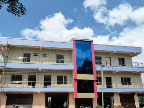 a building with a large glass sculpture in front of it at New Projapati Guest House, Prantik Road in Shānti Niketan