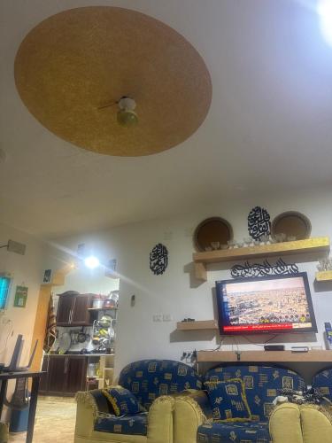 a living room with couches and a flat screen tv at Arabian luxury Farmhouse Oasis Private & Cozy 