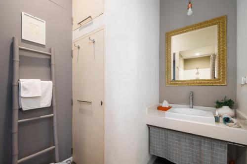 a bathroom with a sink and a mirror at Non Inn Entire Historic 5 Bedroom Riverside Shophouse near ICONSIAM for Families and Groups in Bang Rak