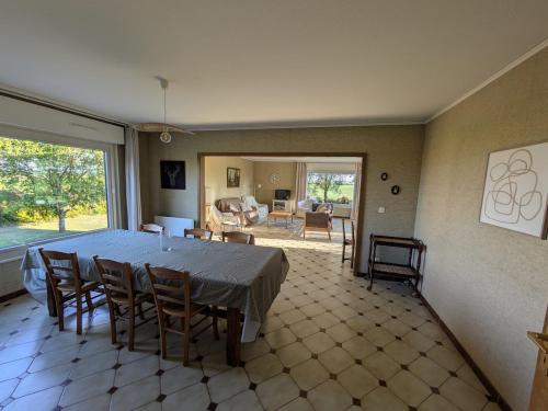 a large dining room with a table and chairs at Maison de location in La Malmaison